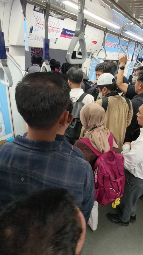 Commuters Exiting Jakarta MRT Train at Their Destination During Rush Hour Stock Footage 338316673