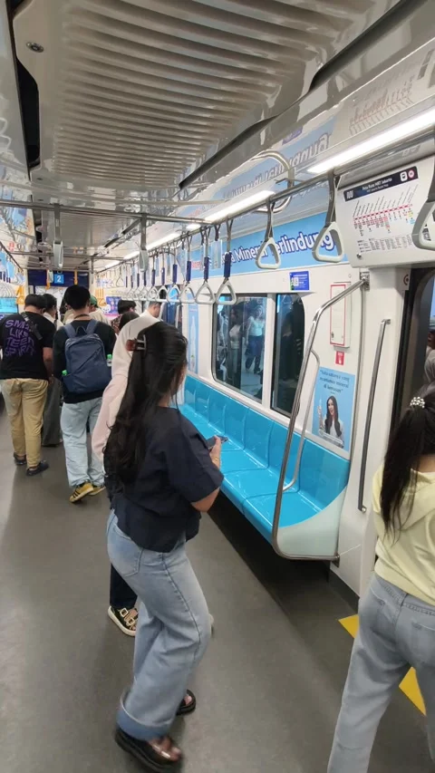 Commuters Exiting Jakarta MRT Train at Their Destination During Rush Hour Stock Footage 338316687