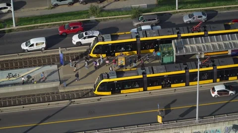 Commuters getting on and off the Combino tram at the Infopark stop between the Stock Footage 296364810