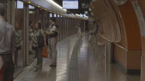 Commuters getting into the train at railway platform Stock Footage 73699119