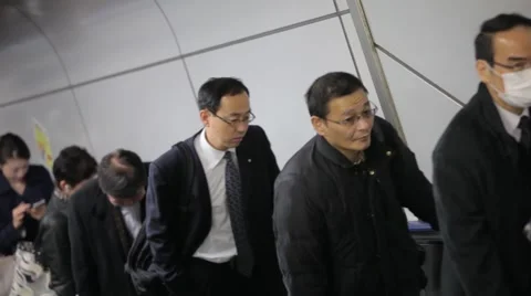 COMMUTERS GOING UP ESCALATOR AT BUSY TRAIN STATION DURING RUSH HOURS IN TOKYO  Stock-Footage 59922038