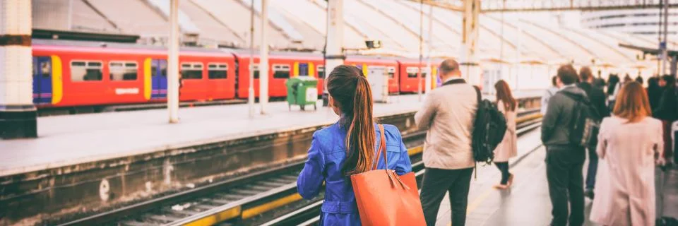 Commuters going to work waiting at train station platform in London city, UK Stock Photos
