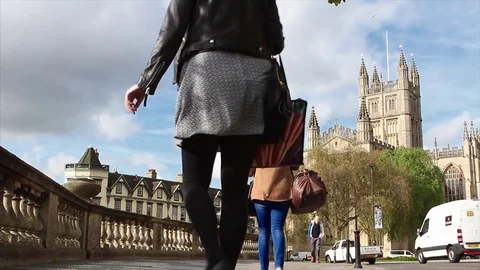 Commuters head towards Bath Abbey on a sunny Spring morning 스톡 동영상 74351431