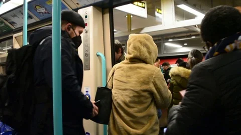 Commuters leaving train car, man wearing face mask Stock Footage 126298233