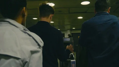 Commuters on London underground using exit gates with oyster cards Stock Footage 88955943