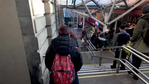 Commuters moving through a busy transportation hub at Waverley Market Stock-Footage 333373605