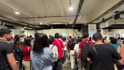Commuters at MRT-3 Taft Avenue Station, Metro Manila 4K 60fps Video stock 338349942