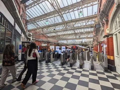 Commuters navigating ticket barriers at the bustling London Underground Stock Photos