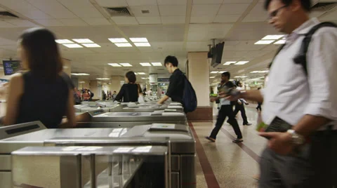 Commuters pass through turnstiles of Rapid Transit System Video stock 34434868