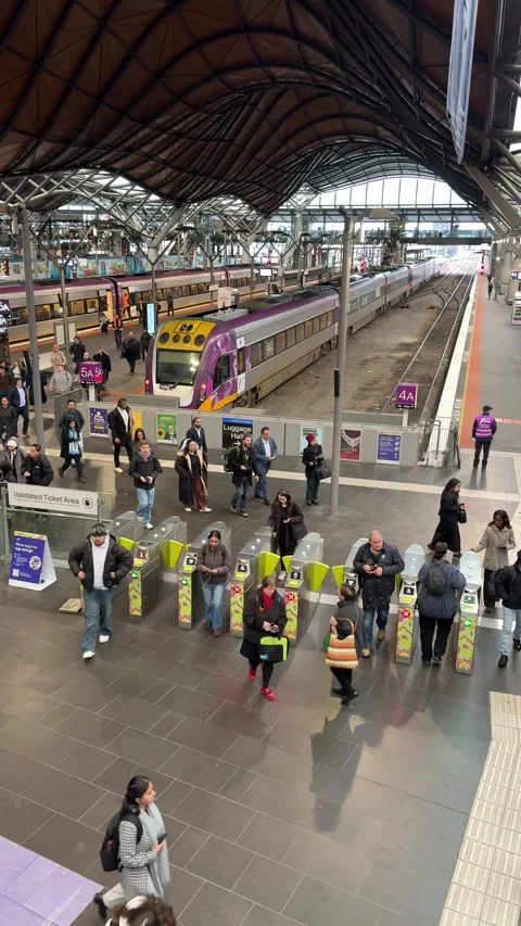 Commuters Passing Ticket Gates at Melbourne Southern Cross Railway Station 動画素材 340678954