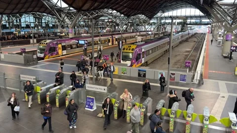 Commuters Passing Ticket Gates at Melbourne Southern Cross Railway Station Stockbeeldmateriaal 340680498