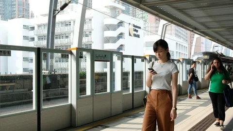 Commuters on the platform of Ma on shan line MTR station Stock Footage 94817016