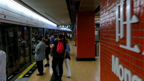 Commuters on the platform of Mong Kok MTR station in Hong Kong Stock Footage 79054517