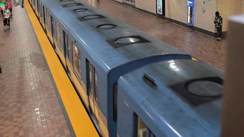 Commuters prepare to board as a metro train enters McGill Station Stock Footage 339641192