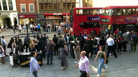 Commuters queue for a packed London bus. During rail strike. Video stock 197817823