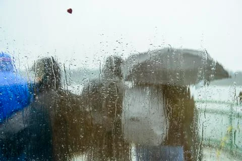 Commuters in rain with umbrella Foto stock