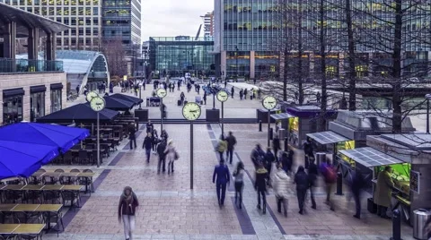 Commuters at rush hour with clocks in Docklands Stock Footage 51147600