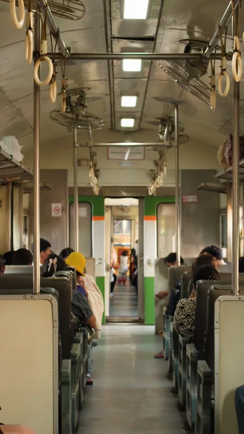 Commuters Sitting in a Vintage Train Carriage in Bangkok Thailand Video stock 328699019