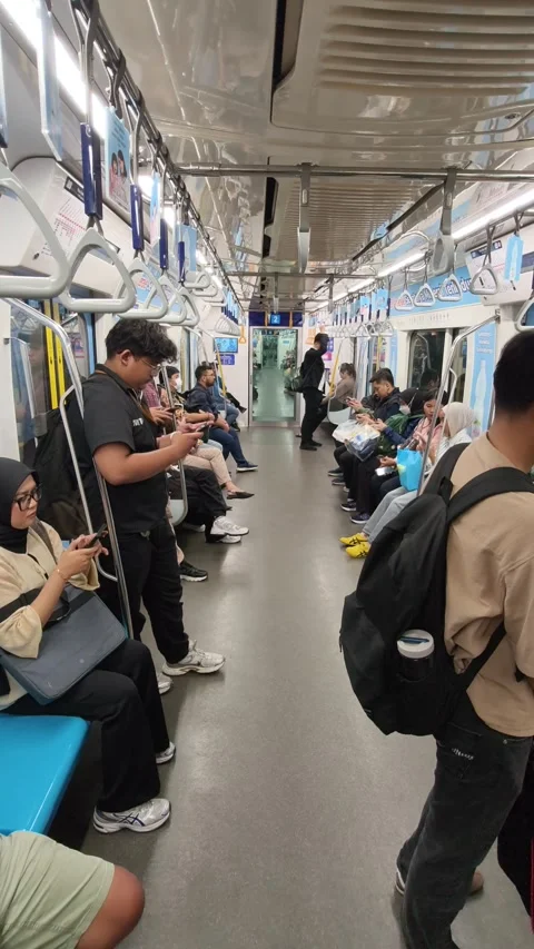 Commuters Standing Inside a Jakarta MRT Train During Off-Peak Hours Stock Footage 338316669