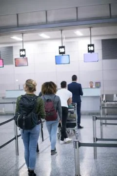 Commuters standing in queue for check-in Stock Photos