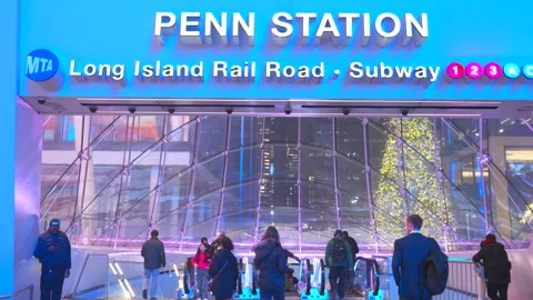 Commuters take elevator to Penn Station beneath glowing Christmas Tree Stock Footage 295916186