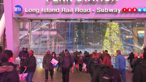 Commuters take elevator to Penn Station beneath glowing Christmas Tree Stock Footage 295917650