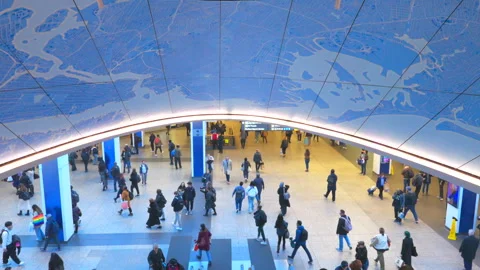 Commuters take elevator to Penn Station beneath glowing Christmas Tree Stock Footage 295930905
