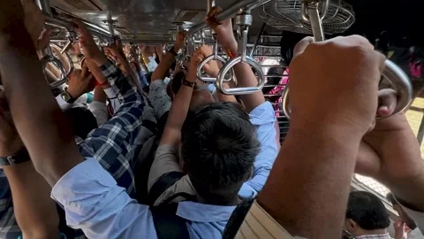 Commuters traveling in an extremely crowded local train in Mumbai, India Stock Footage 339339848
