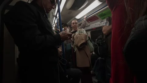 Commuters traveling inside a moving underground transit rail car Vídeos de archivo 334327340