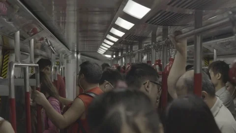 Commuters travelling in a crowded train Stock Footage 73699118