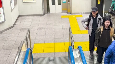 Commuters Using Escalators in a Busy Tokyo Subway Station Stock Footage 336715098