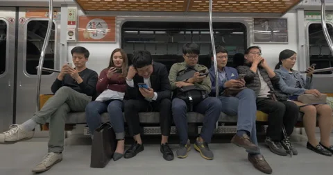 Commuters using mobile phones in subway. Seoul, South Korea Stock Footage 66968748