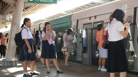 Commuters using phones and waiting for boarding city train Stock-Footage 106925403