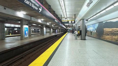 Commuters wait on the platform at Sheppard West subway station in Toronto. 스톡 사진