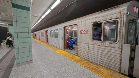 Commuters wait on platform for subway train in Toronto 스톡 사진
