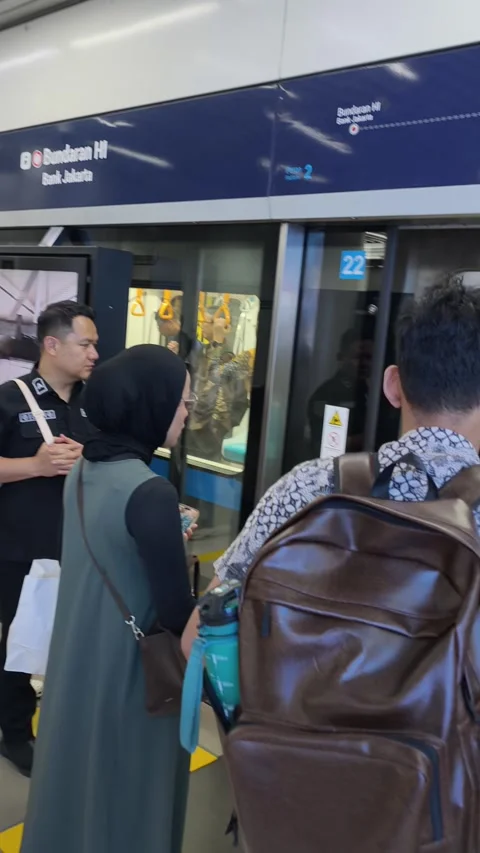 Commuters Waiting on the Platform to Board a Jakarta MRT Train Stock Footage 338316859