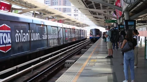 Commuters Waiting as Skytrain Arrives at Elevated Bangkok Station Stock Footage 323679820