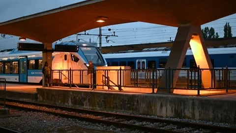 Commuters waiting for train departure at train station platform Stock Footage 170665914