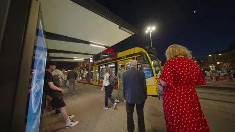 Commuters waiting at the tram stop. Budapest, Hungary - may 31, 2025 Stock Footage 314651553
