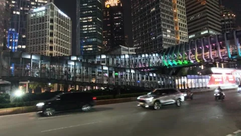 Commuters Walk Across an Elevated Pedestrian Bridge Stock Footage 338444659