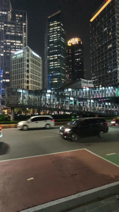 Commuters Walk Across an Elevated Pedestrian Bridge Stock Footage 338446132
