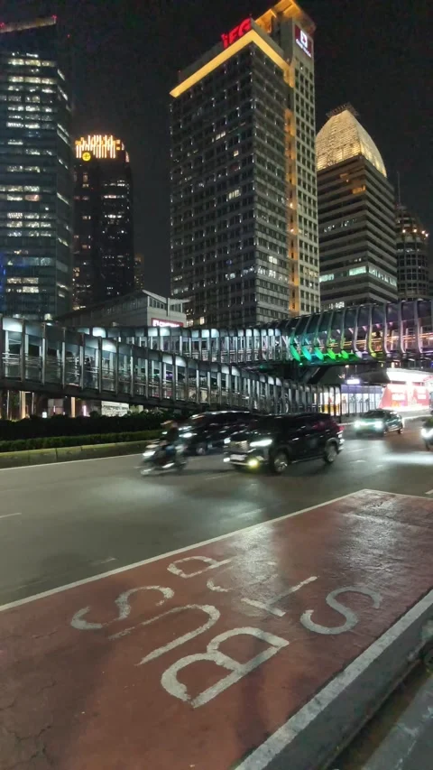 Commuters Walk Across an Elevated Pedestrian Bridge Stock Footage 338446145