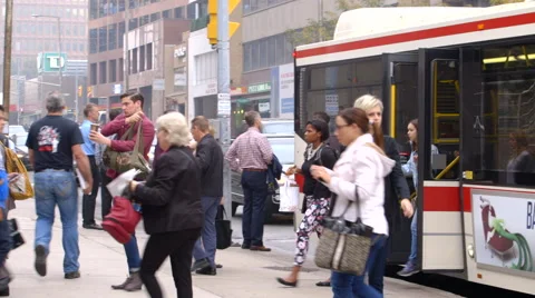 Commuters walk off of bus and into subway station Stock Footage 44265748