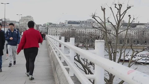 Commuters walking across Waterloo Bridge Stock Footage 93866771