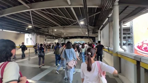 Commuters Walking on MRT-3 Station Footbridge, Pasay 4K 60fps Video stock 338349957