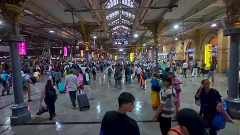 Commuters walking through the main hall of the bustling CSMT station Stock Footage 338171525
