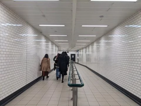 Commuters walking through a tiled underground pedestrian tunnel at Knightsbridge Stock Photos