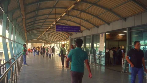 Commuters walking towards Mumbai Metro station, Queue inside booking office for Video stock 310331069