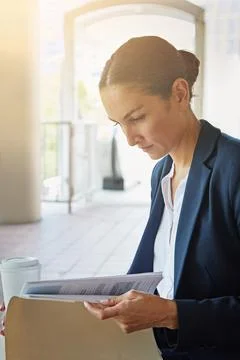 Commutings a great time to prep for the work day. a businesswoman reading Stock Photos