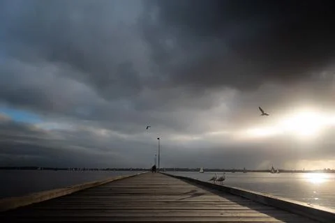 Como jetty with looming clouds at Perth, Western Australia Stock Photos